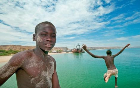 Two locals dive into the breathtaking waters surrounding Lucira Beach in Angola