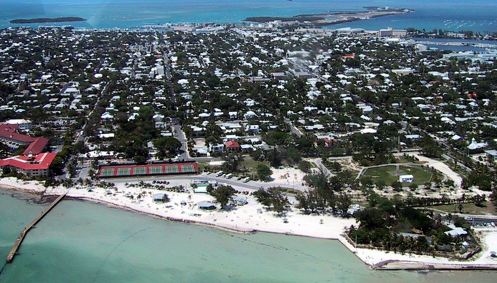 Aerial view of Key West Florida highlighting pristine beaches, the town, and the port in the distance