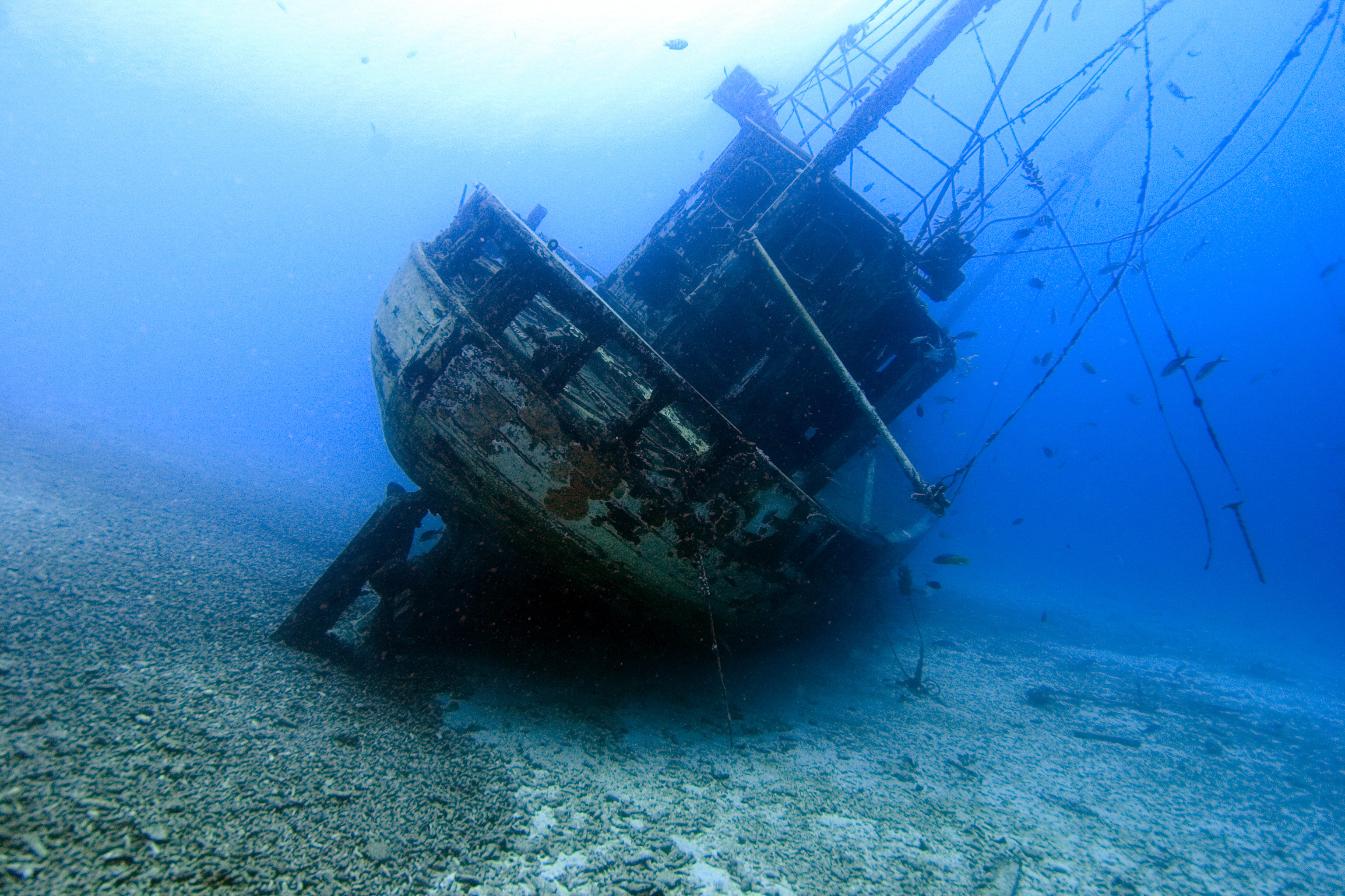 Large wreck rests along the sandy bottom in the Caribbean waiting to be explored by divers