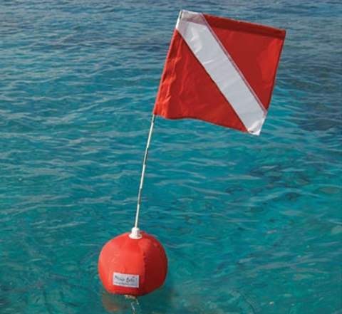 Diver down flag attached to a buoy marks the spot of an underwater diver in the Florida Keys