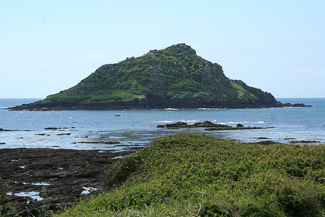 Great Mew Stone surrounded by rocky outcroppings; viewed from Wembury Point