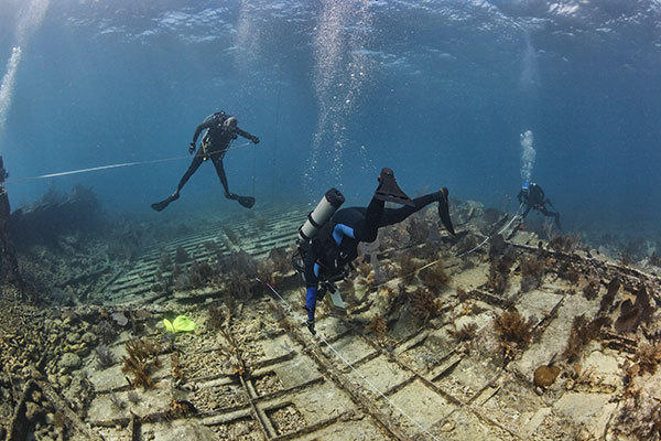 Divers in Key Largo, Florida surveying the wreck of the Hannah M. Bell, a well preserved steamer
