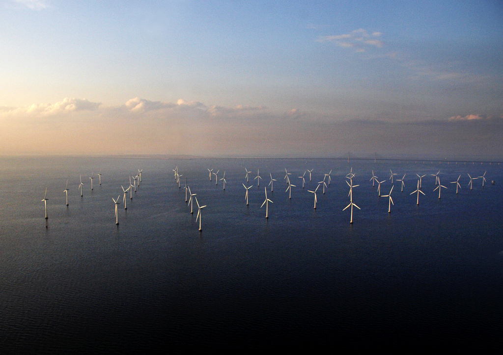 Aerial view of a large collection of wind turbines that provides power to many and reduces carbon dioxide emissions