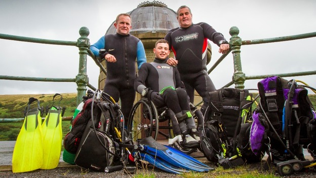 Josh Davies along with his instructor Dai Mathias and Mark Thomas pose for photos in front of their scuba gear