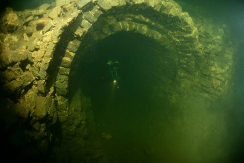 Diver exiting a passageway found along the underwater great wall of china