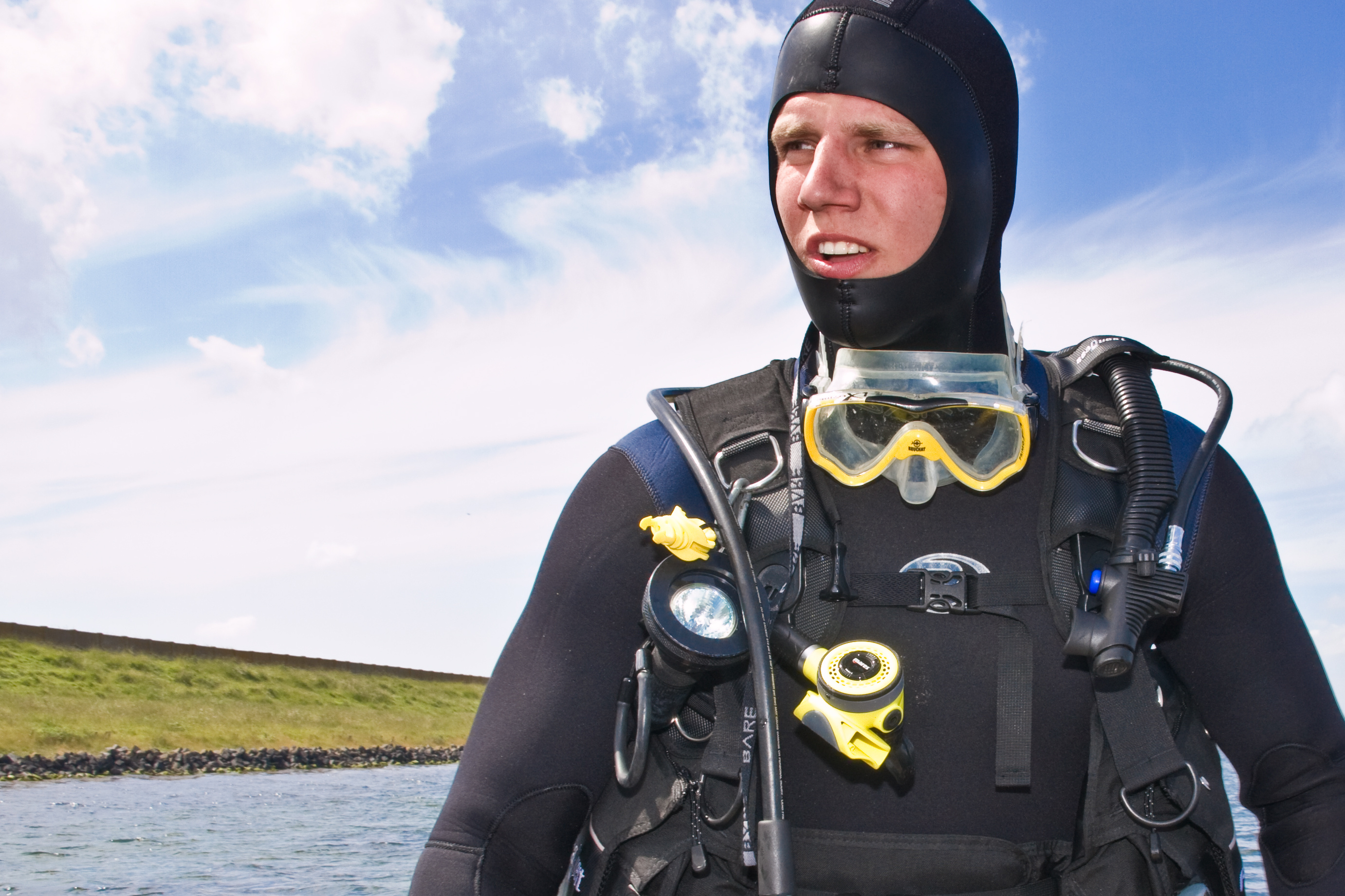 Male diver chooses to wear heavy wetsuit, hood, and gloves on all dives he takes in the Pacific Northwest