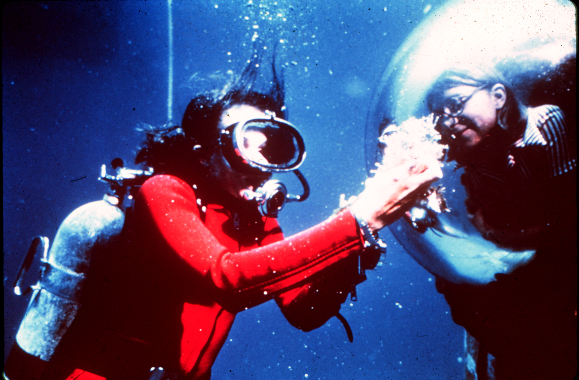Diver, Dr. Sylvia Earle, shows marine life samples to aquanaut inside TEKTITE 