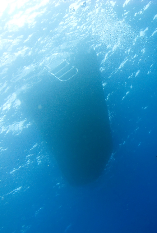 The bottom of a dive boat with its ladder still in the water at a Florida dive site where two divers lost their lives