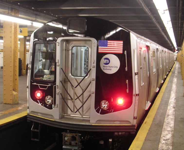 NYC subway train makes a stop at 14th street to pick up daily commuters