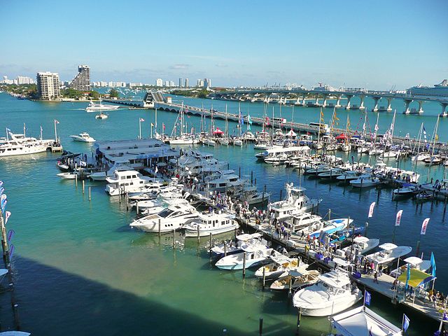 The Sea Isle Marina in Miami with a variety of boats docked and the city in the background