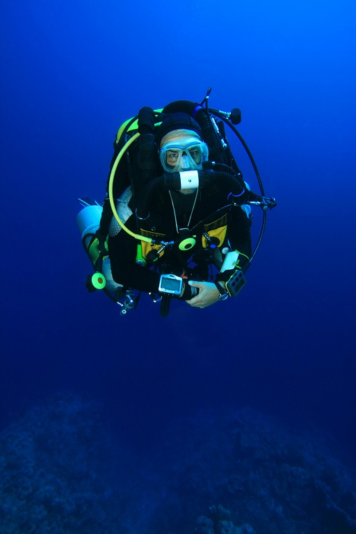 Diver practices skills learned during his rebreather diving training certification class