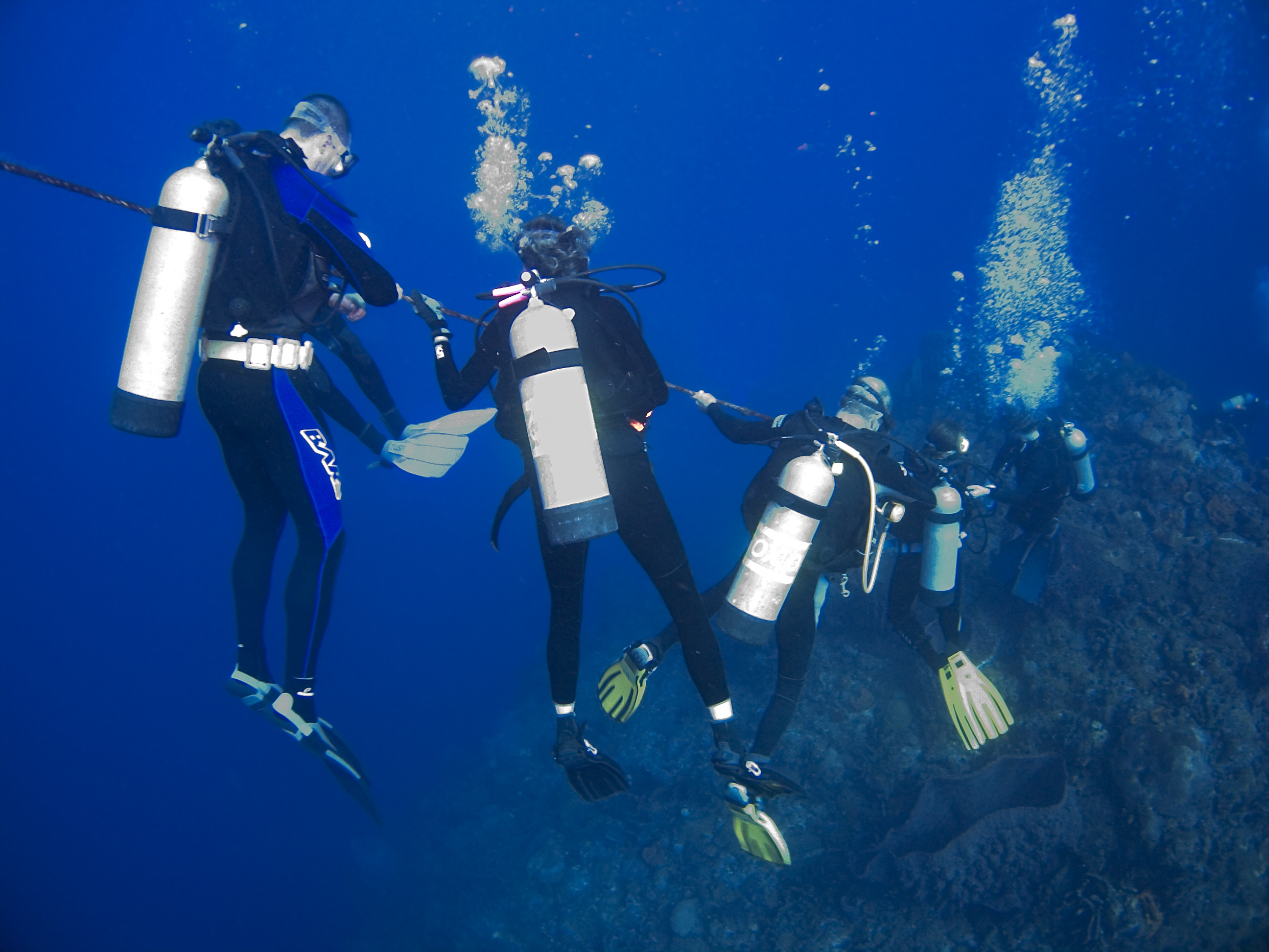 Group of divers decide to take deep stop at 65ft as part of their ascent back  to the surface