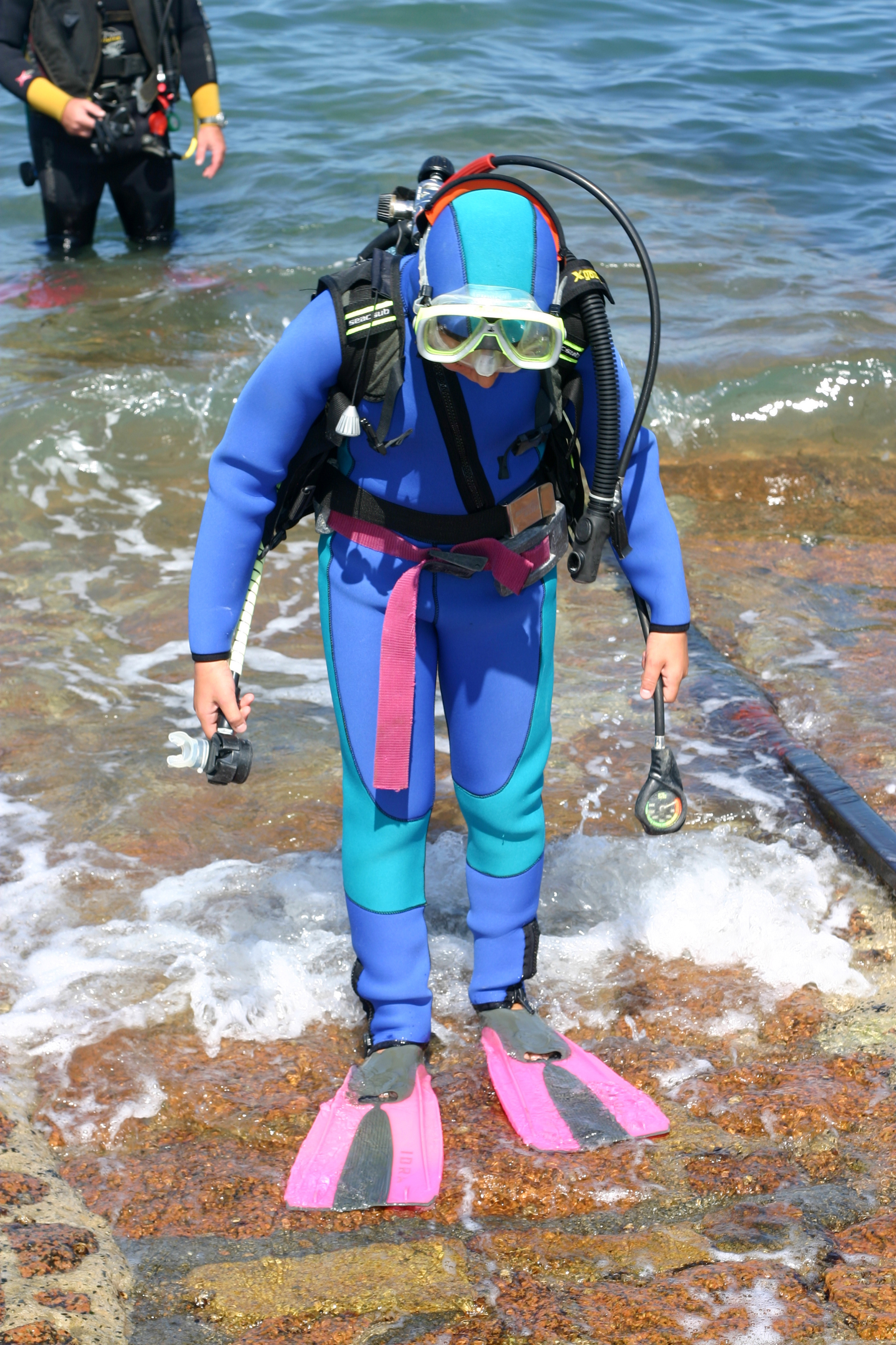 Scuba diver makes it back to shore safely after following best practices for water entries and water exits