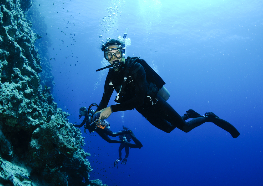 Two divers help ensure that they remain safe on each dive by maintaining their fitness level and being properly equipped