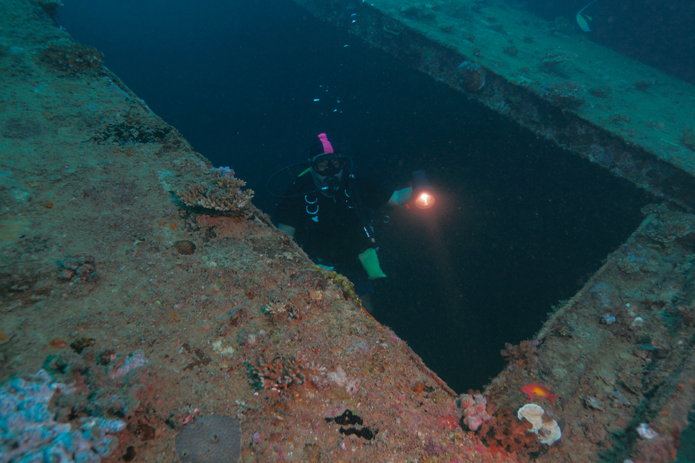 Wreck diver begins to exit the wreck shortly after penetration so that she remains within the limits of her diving