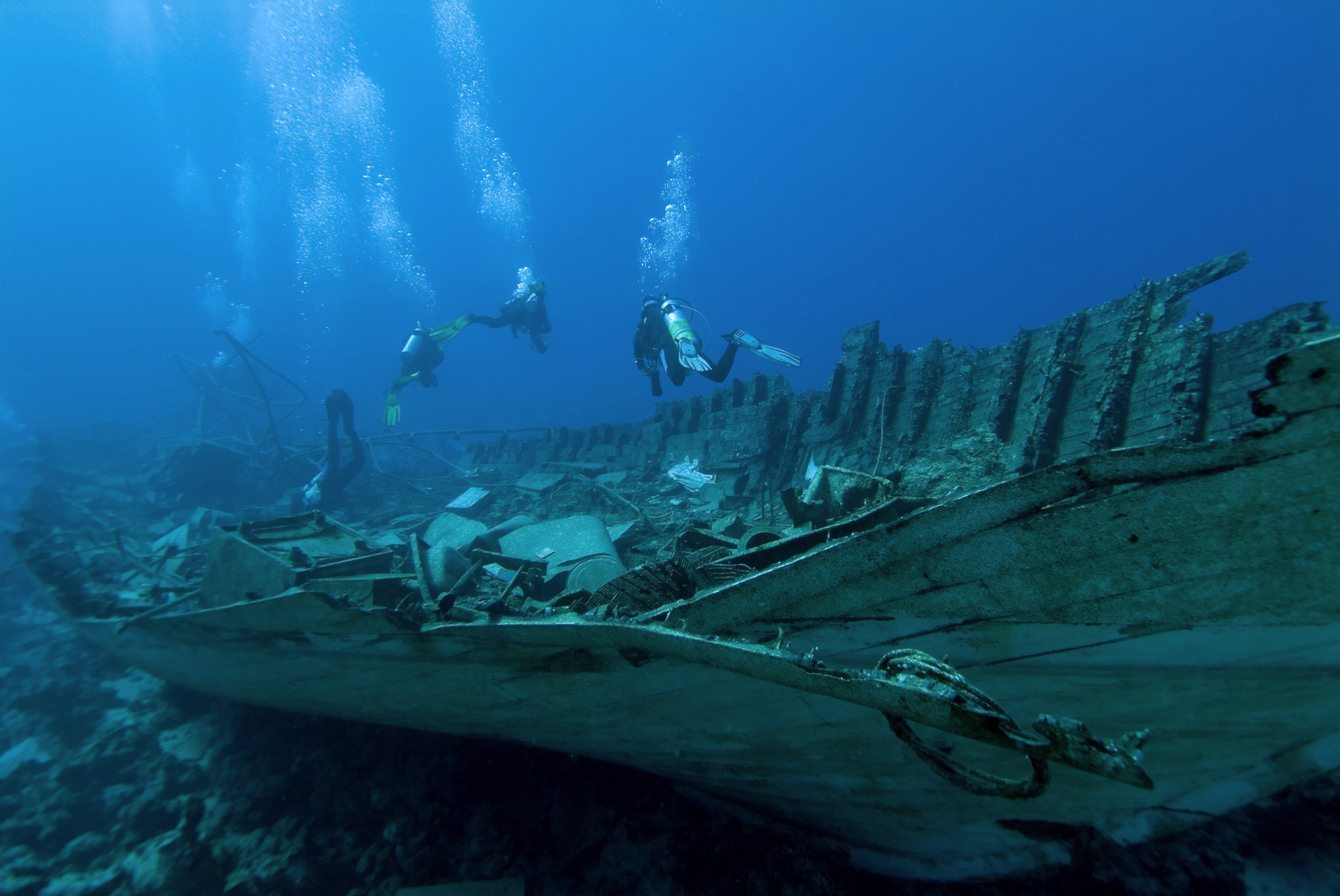 salvage divers surveying a underwater wreck