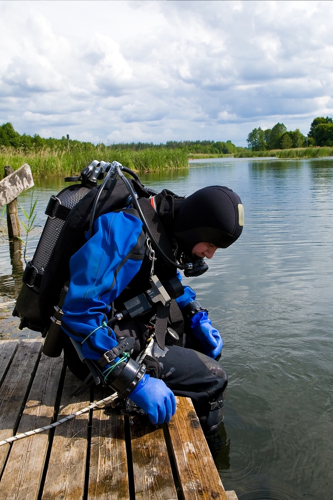 hazmat diver in full gear getting ready to survey toxic spill site