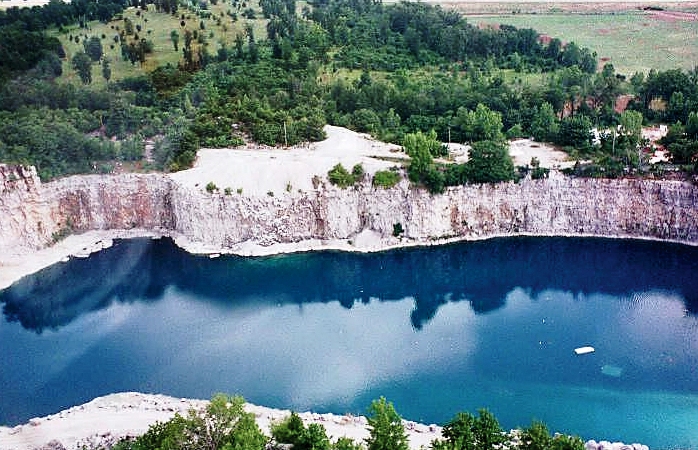 Aerial view of Alabama&#039;s Madison Quarry surrounding by rock and lush greenery