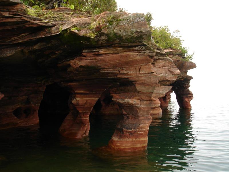A series of sea caves on Devil's Island covered with lush greenery are a top destination among divers and other adventurers