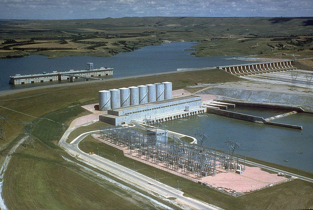 Panoramic view of Fort Randall Dam with Lake Francis Case in the background surrounded by lush greenery
