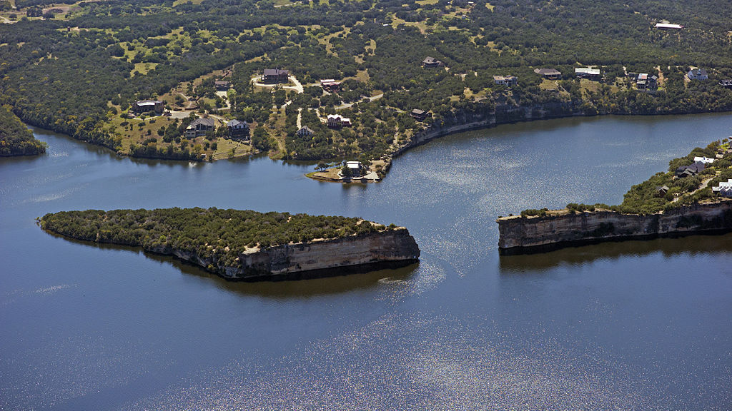 Aerial view of Possum Kingdom Lake in Texas surround by mountains covered in lush greenery