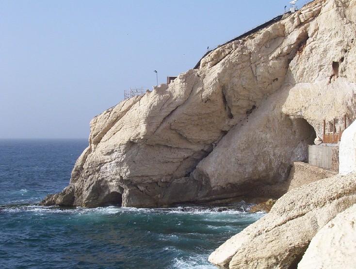 A tiny entrance built into the rocky cliff face leads divers into the beautiful Rosh HaNikra Caverns