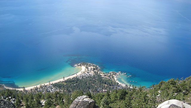 Aerial view of Sand Harbor State Park in Nevada with its sandy beaches and lush greenery surrounded by beautiful blue water
