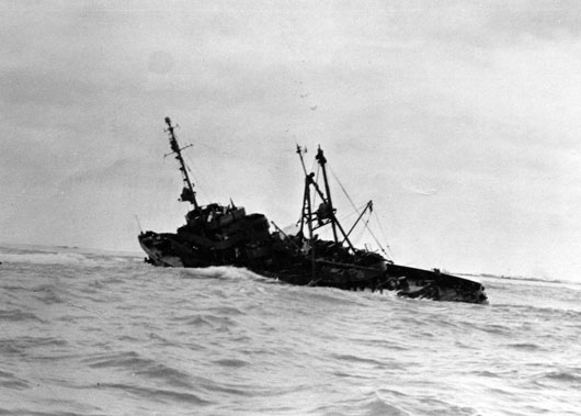 The USS Macaw resting on the reef she collided with in the Midway Islands in January 1944