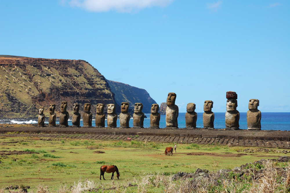 Moai statues sit in solid line at Ahu Tongariki on Chile&#039;s Easter Island; beneath the waters, an underwater moai awaits divers