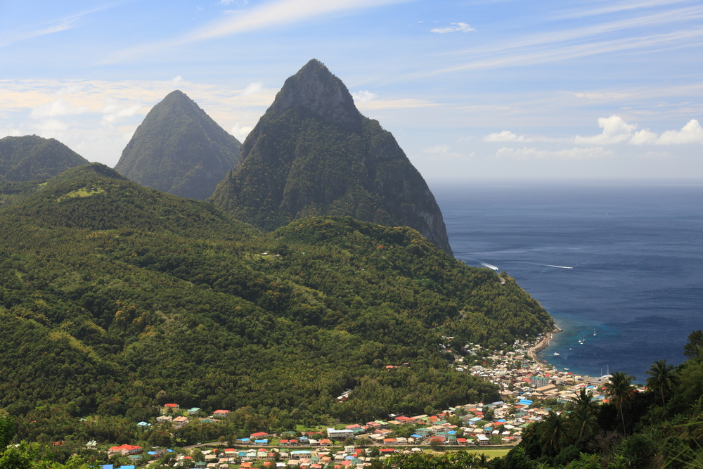 Saint Lucia&#039;s famous mountains, two pitons, provide a beautiful backdrop against the country&#039;s blue waters and white sandy beaches