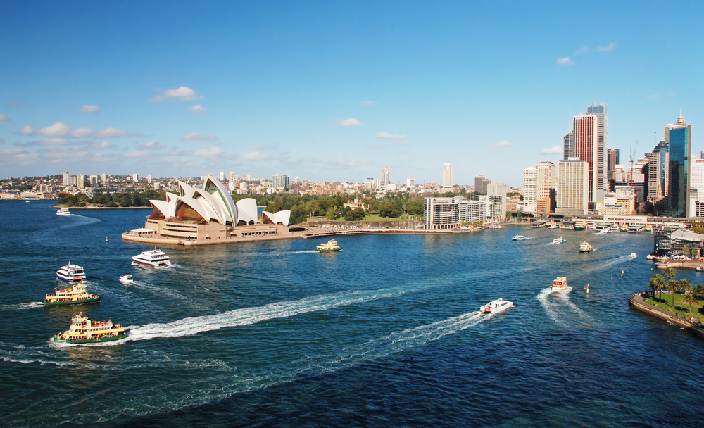 Picturesque skyline of Sydney, Australia including Sydney Opera House as tour boats explore the waterways