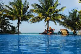 Couple enjoying some R&amp;R by the pool at the Hamanasi Adventure Dive and Resort in Belize